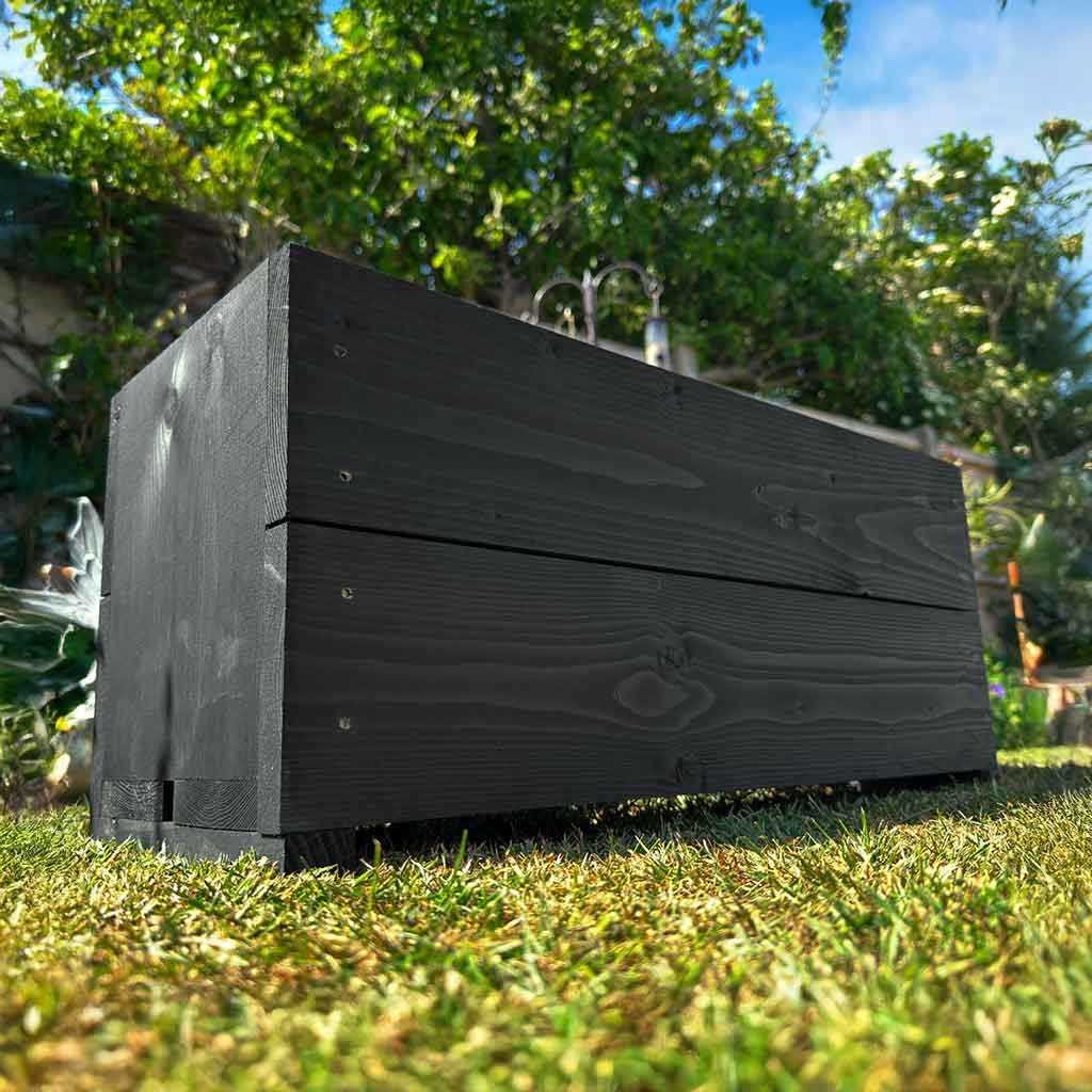 Black Hastings wooden garden planter, lined and planted