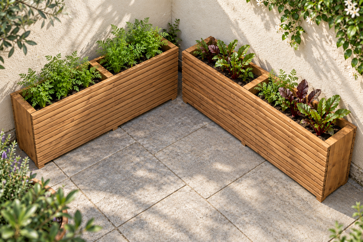 Two extended tan Sussex planters arranged along adjoining courtyard walls with different vegetable planting.